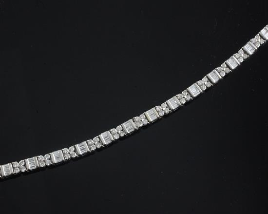An 18k white gold and diamond line bracelet, 18.5cm.